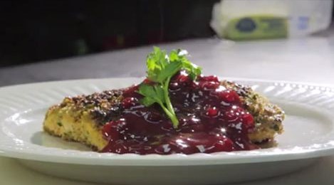 Plate of salmon with cherries on top