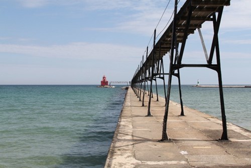 Pier with red lighthouse in the distance