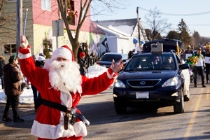Santa standing in a parade.