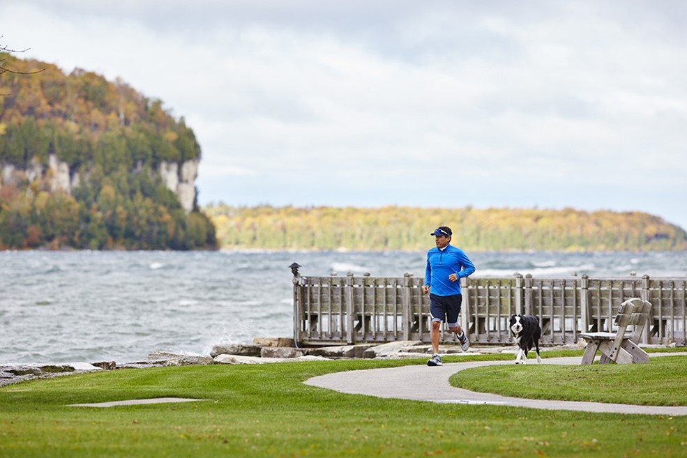 A man running along a path at the edge of the lake.