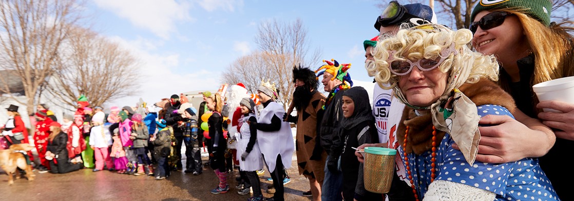 People dressed up in costumes preparing for a run