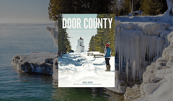 Door County 2021 Peninsula & Washington Island guide overlaying a icy shoreline background.