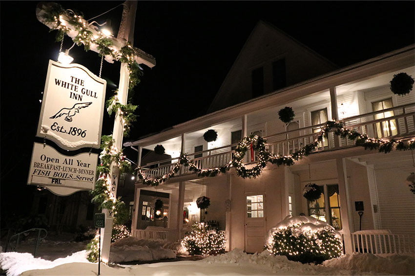 The White Gull Inn lit up at night.