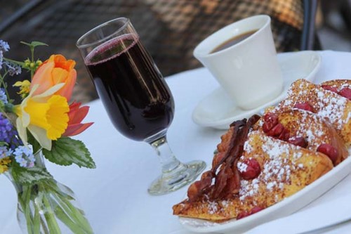 A plate of cherry French toasts aside hot coffee and fresh cherry juice at White Gull Inn.