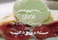 The words Savor Door County over an image of a cherry pie with ice cream.
