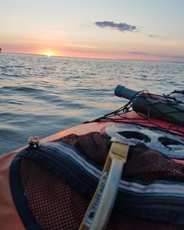 A kayak on the lake at sunrise.