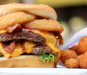 Closeup of a burger with cheese curds.