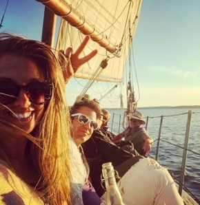 People taking a selfie on a sailboat