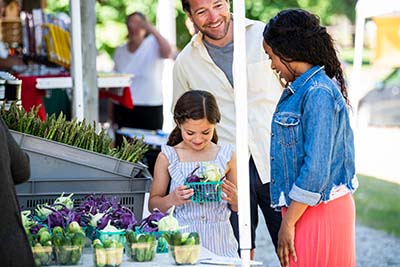 A family at a farmers market.