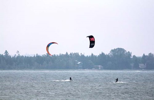 Two kiteboarders spending time on the water.