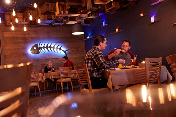Couples dine at a seafood and sushi restaurant