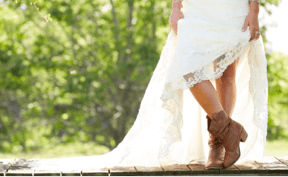 Woman in wedding dress showing her boots.