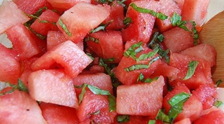 Closeup of watermelon chunks with minced basil.