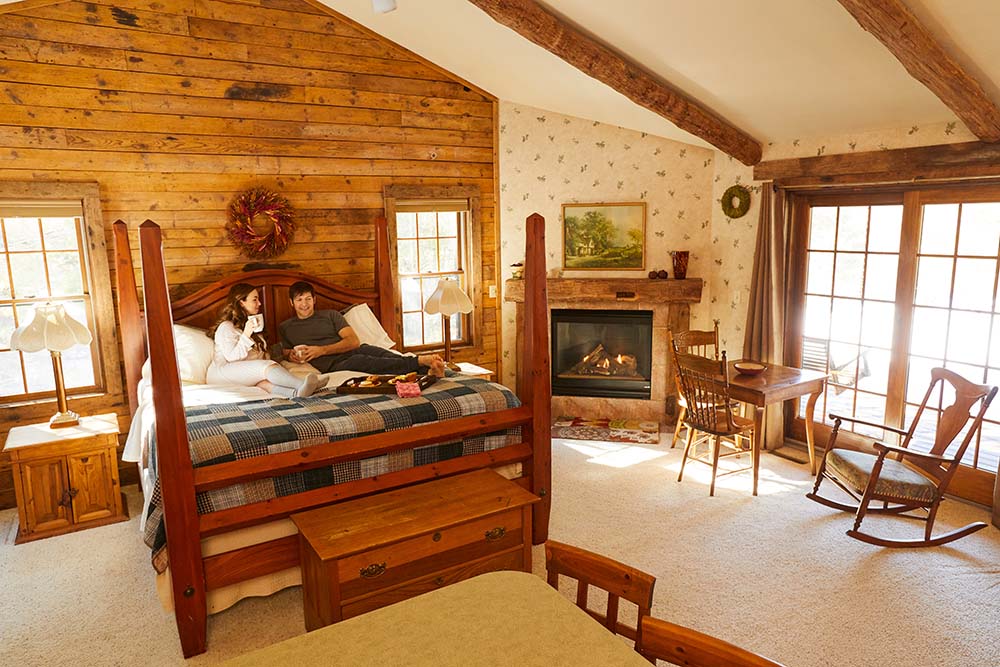 A couple laying on a bed in their cabin