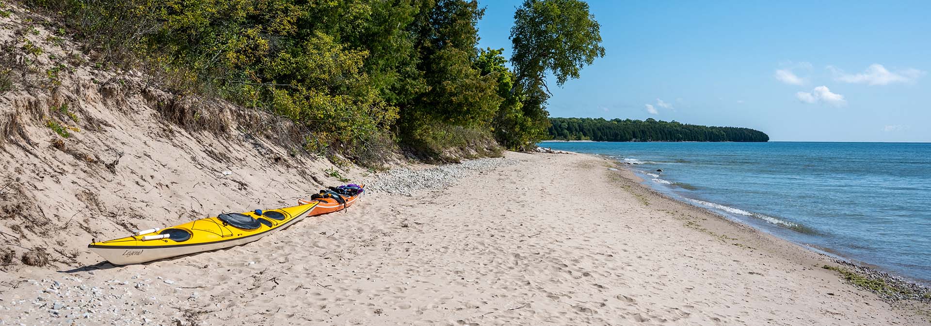 A beach with a kayak on the sand