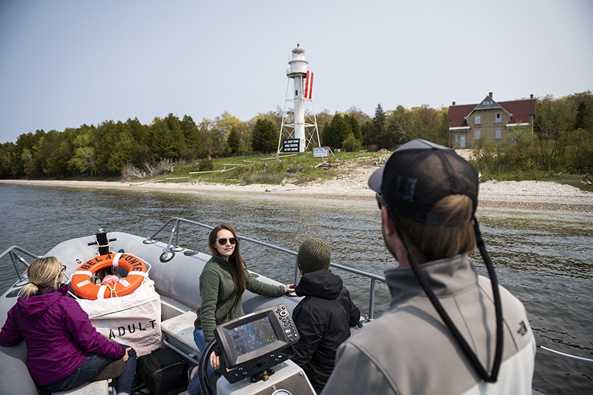 Friends take a boat tour along the shoreline