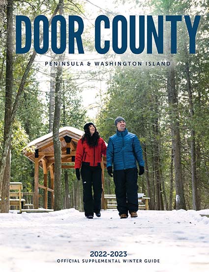 The cover of the Winter Guide with a couple hiking in snowy woods.