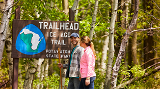 Two people walking toward Ice Age Trailhead