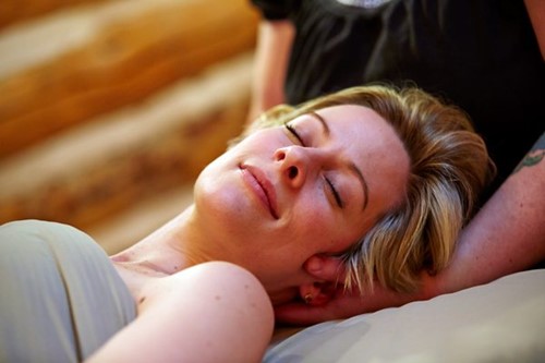 A woman enjoys a massage at a local spa.