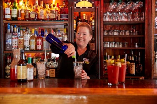 A bartender crafts bloody marys at Coyote Roadhouse.