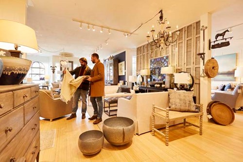 Community Spotlight: Baileys Harbor A couple shops for modern home decor at Nathan Nichols & Company.