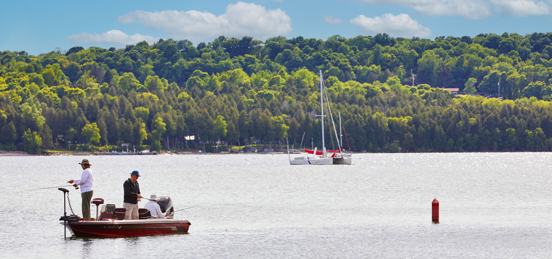 Common Fish of Door County and When to Catch 'em Men fishing on a boat in Door County