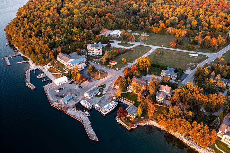 The Full-County Driving Tour A Door County city along the water during the fall with beautiful trees.