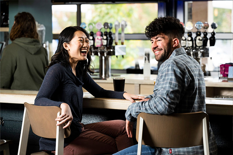 25 Things to Do During Winter in Door County A couple laughing at One Barrel Brewing Company, a popular winter thing to do in Door County.