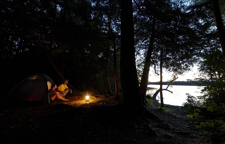Door County-Inspired Cocktails to Sip this Summer Campers beside a fire.