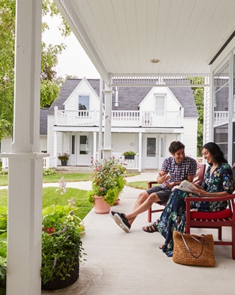 A couple sitting outside of their lodging place