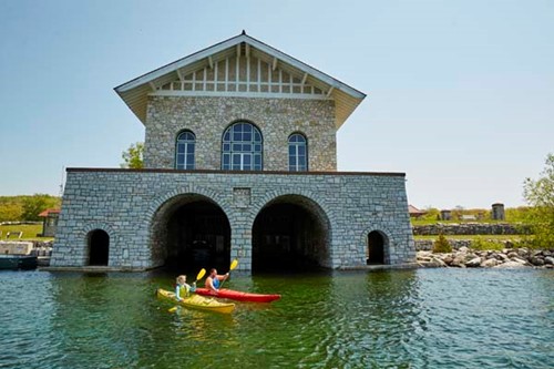 Community Spotlight: Washington Island A couple kayaks in front of the majestic stone Thordarson Boathouse on Rock Island.
