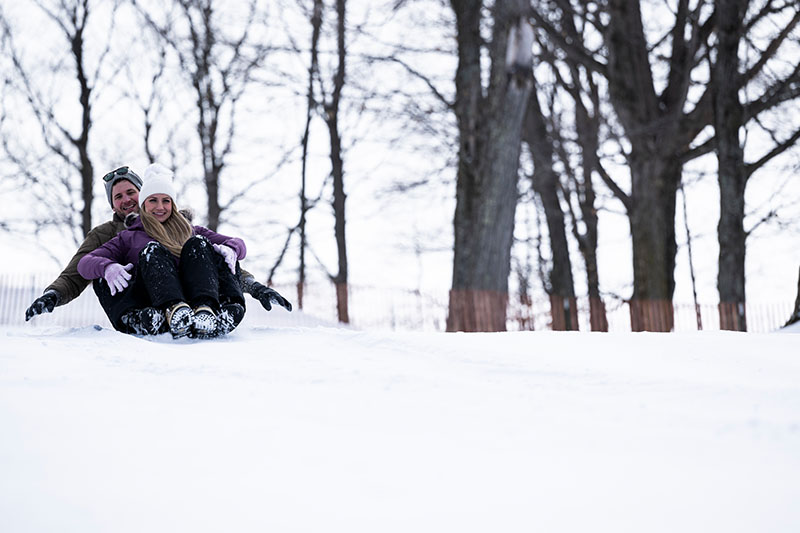 Then and Now: Hill 17 Sledding & Peninsula State Park Ski Jump Couple sledding at Hill 17