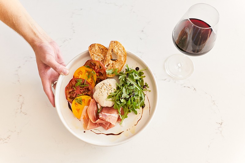 Sustainable Food & Dining in Door County A plate of high-end meats, cheese, and veggies aside a glass of wine