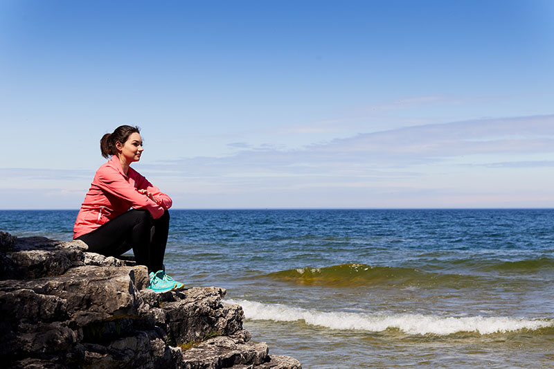7 Ways to Embrace Slow Travel in Door County Enjoying a spring afternoon at Cave Point County Park.