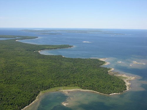 Community Spotlight: Ellison Bay A sweeping aerial view of the northeastern peninsula shoreline, where Newport State Park and the Mink River Estuary lay.