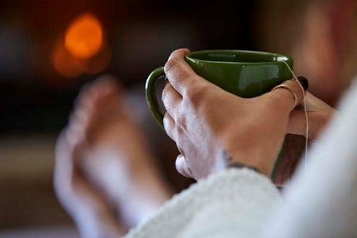 Swedish Heritage in Door County A woman relaxes with hot tea at a spa.
