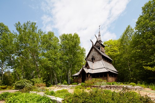 Community Spotlight: Washington Island The grand Stavkirke church in a clearing surrounded by trees.