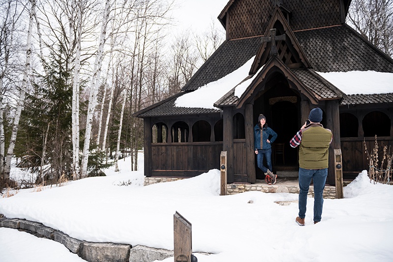 The Stavkirke: Hidden Treasure in the Woods Two friends taking photos at the Stavkirke in winter