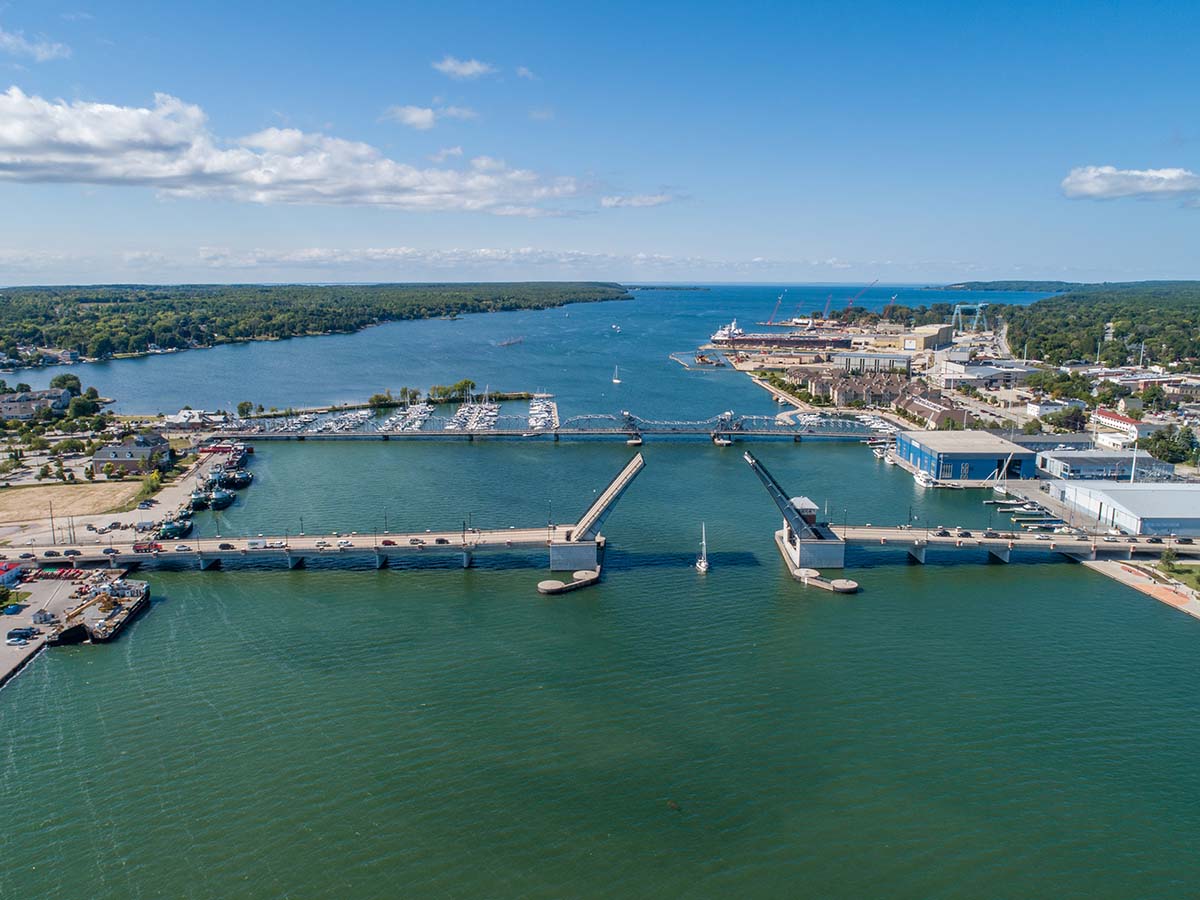 Lakes & Waterways Photo Tour An aerial view of a huge canal with two bridges and Lake Michigan in the distance.