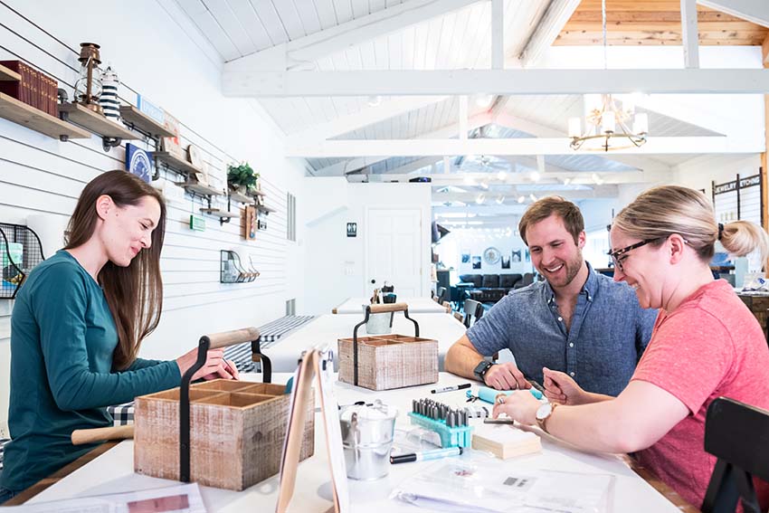 Where to Host a Reunion in Door County Three people sitting at a table making crafts together