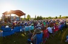 Crowd seated at an outdoor festival.