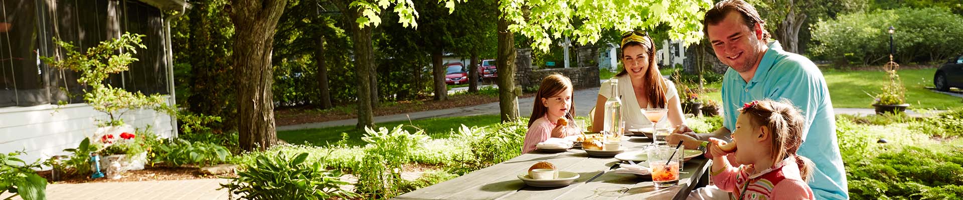 Kid-Friendly Dining A family eating together at a picnic table