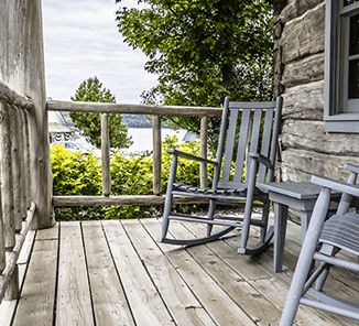 Forestville Two rocking chairs on a wooden porch.
