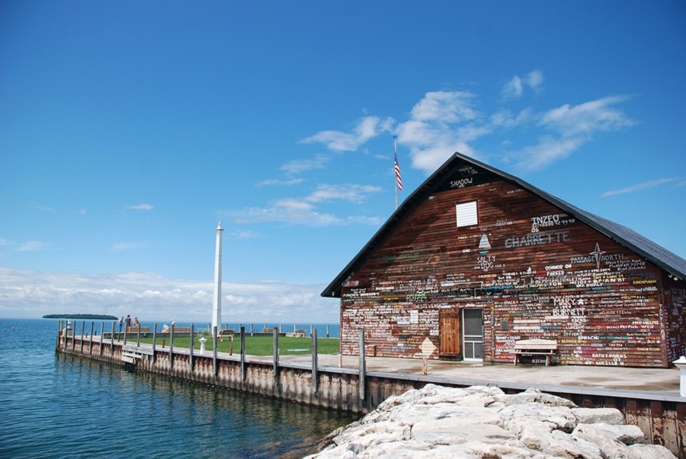 Architecture & Landmarks Wood building with painted words all over it next to the lake.