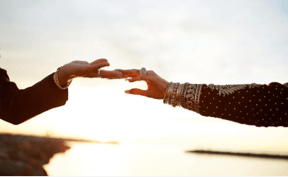 Weddings Two hands touching fingertips.
