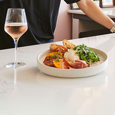 Weddings A plated dish next to a glass of wine
