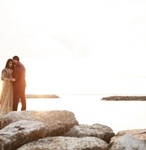 Weddings Couple embracing at the edge of the water