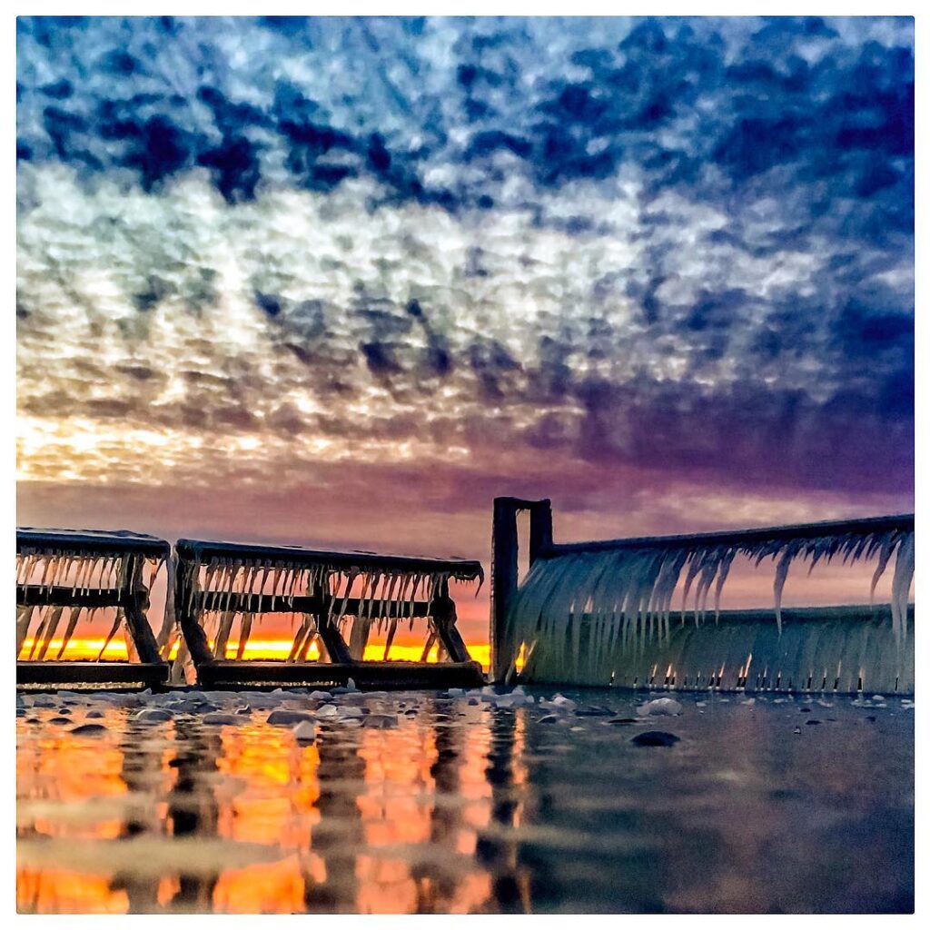 Clouds reflecting off of the water at sunrise.