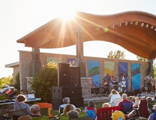 Crowd seated at an outdoor festival.