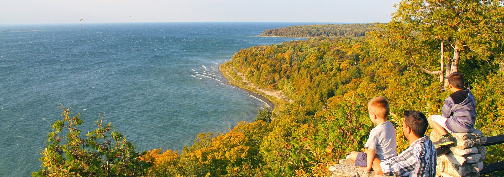 Peninsula State Park Trail Maps A group of boys sitting on a cliff looking out at the lake